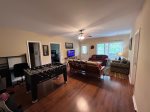 Lower level Den with a flat screen tv steaming only with access to the lower level porch